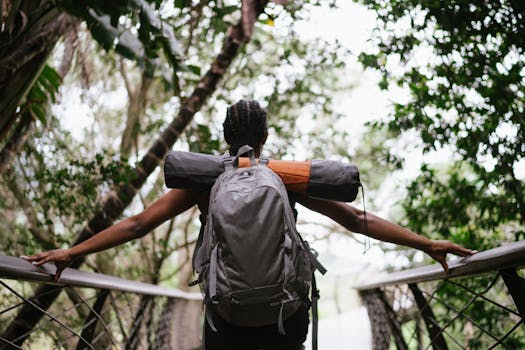 A woman with a backpack enjoys a scenic hike on a forested trail, embracing nature's wonders.